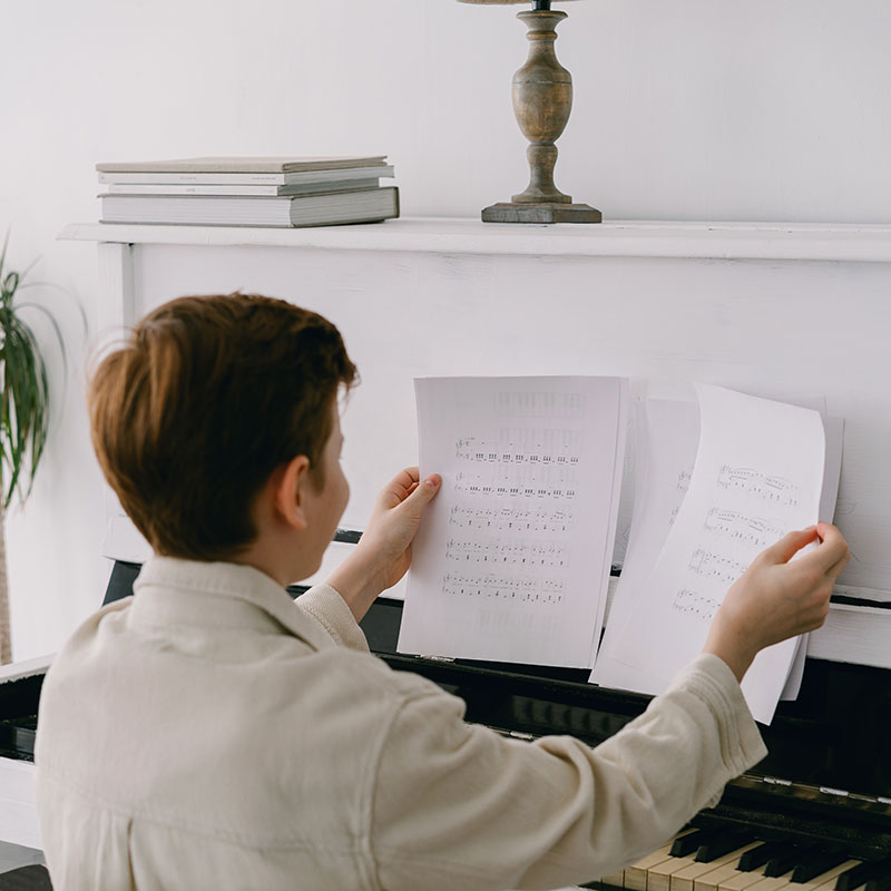 image of boy learning piano
